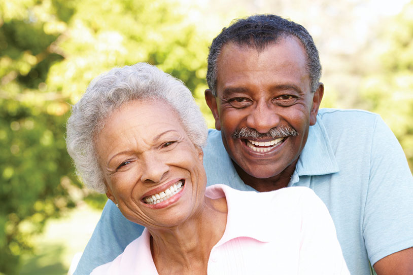 A couple smiling. Links to Beneficiary Designations A couple smiling. Links to Beneficiary Designations
